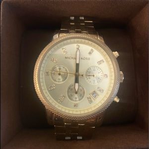 Michael Kors yellow gold pre-owned watch. Needs a battery. Comes with box.
